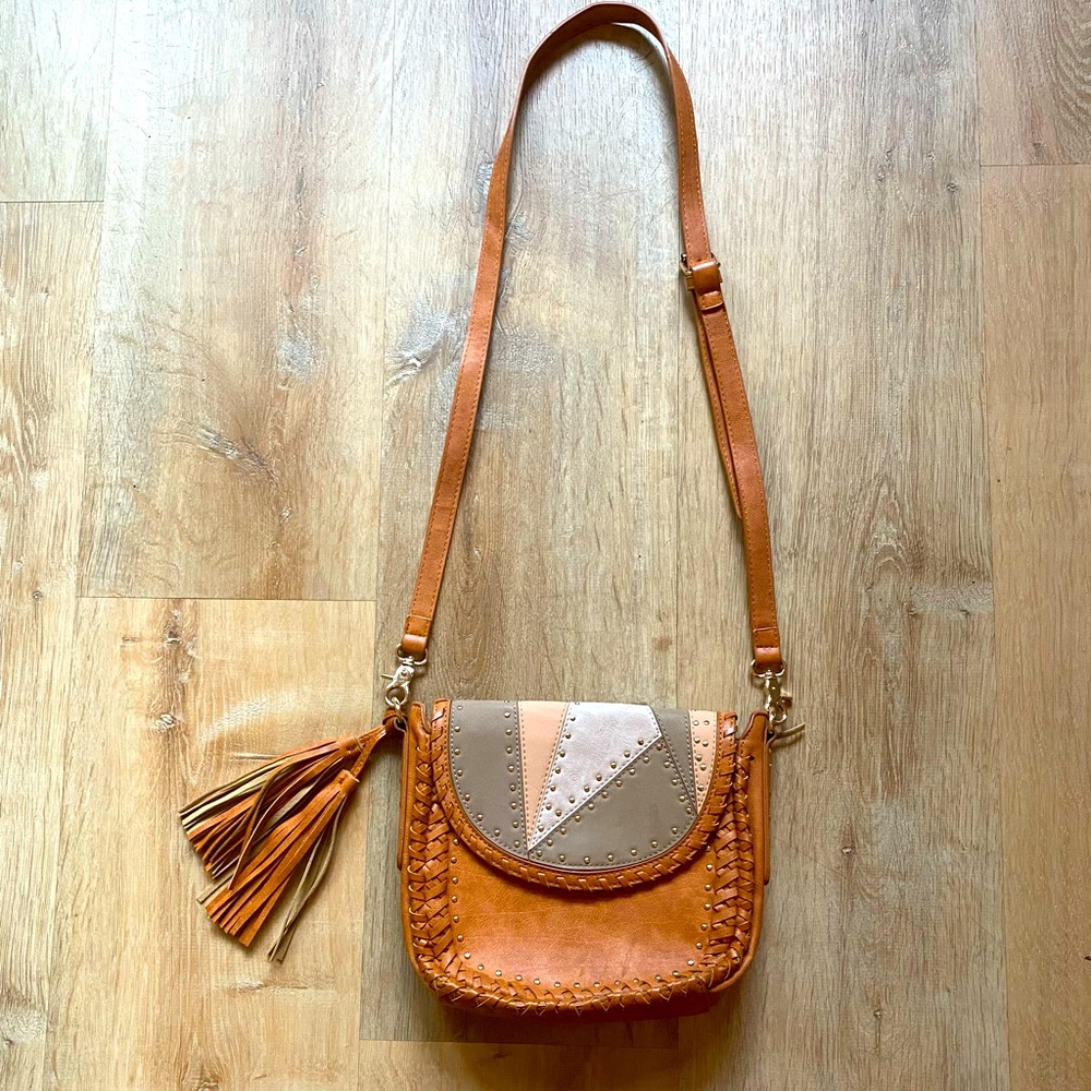 Cognac tan leather saddle bag. Woven Crossbody studded purse with fringe tassels